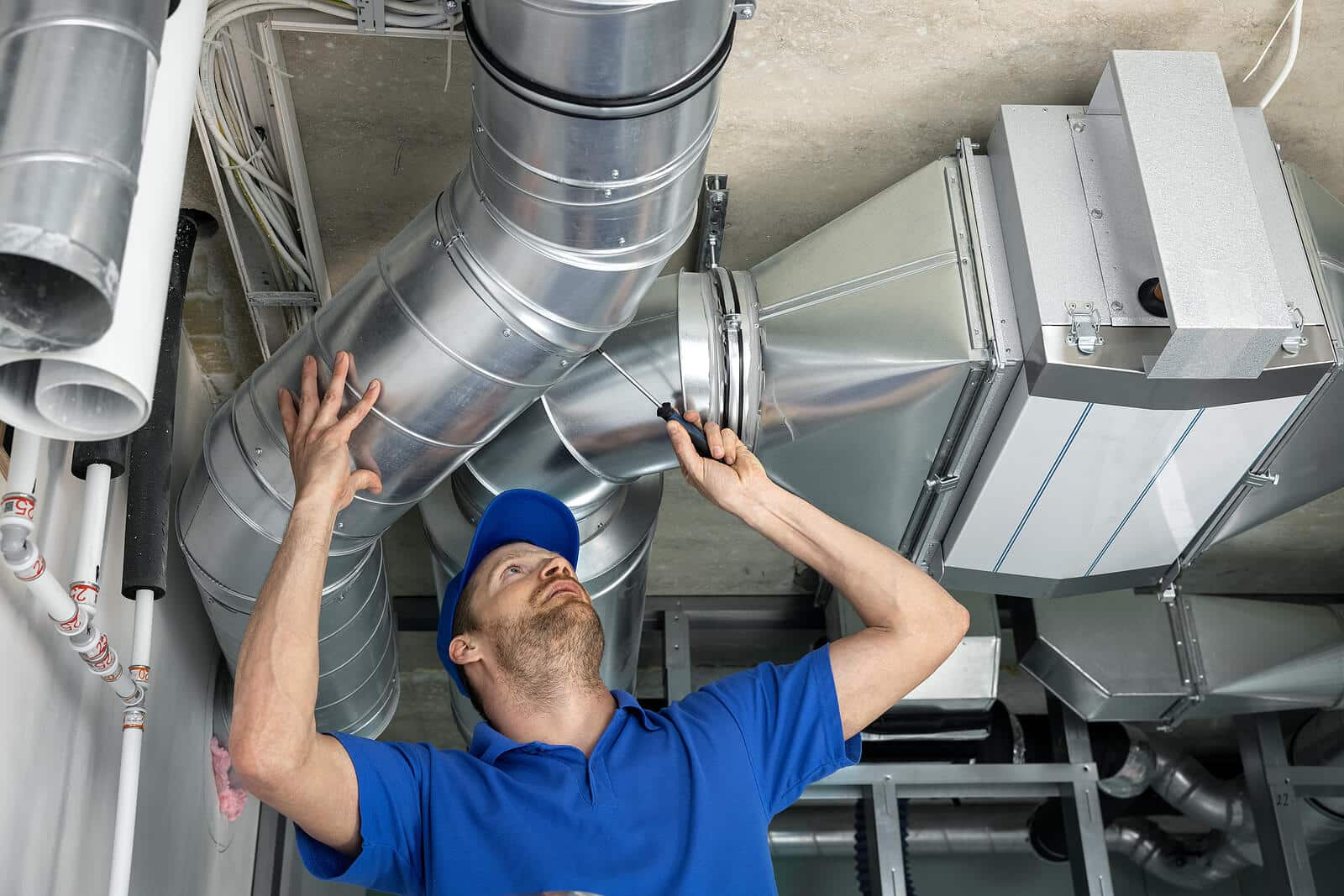 HVAC technician inspecting and repairing air ducts in Oakdale