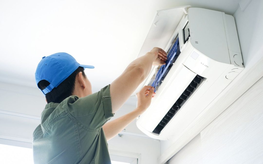 HVAC technician servicing a ductless mini split in Oakdale