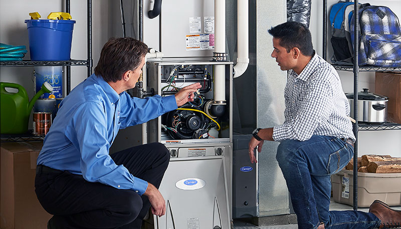 Technician evaluating a furnace for repair or replacement in Oakdale