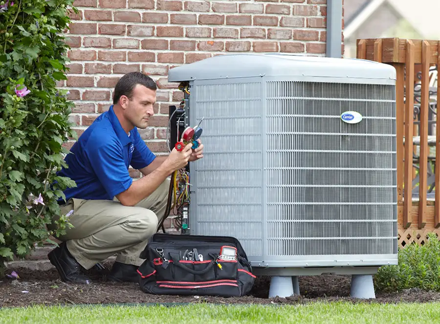 HVAC technician inspecting an outdoor AC unit in Oakdale